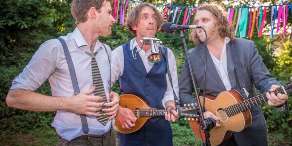 Trio-Of-Musicians-Performing-At-Outdoor-Festival