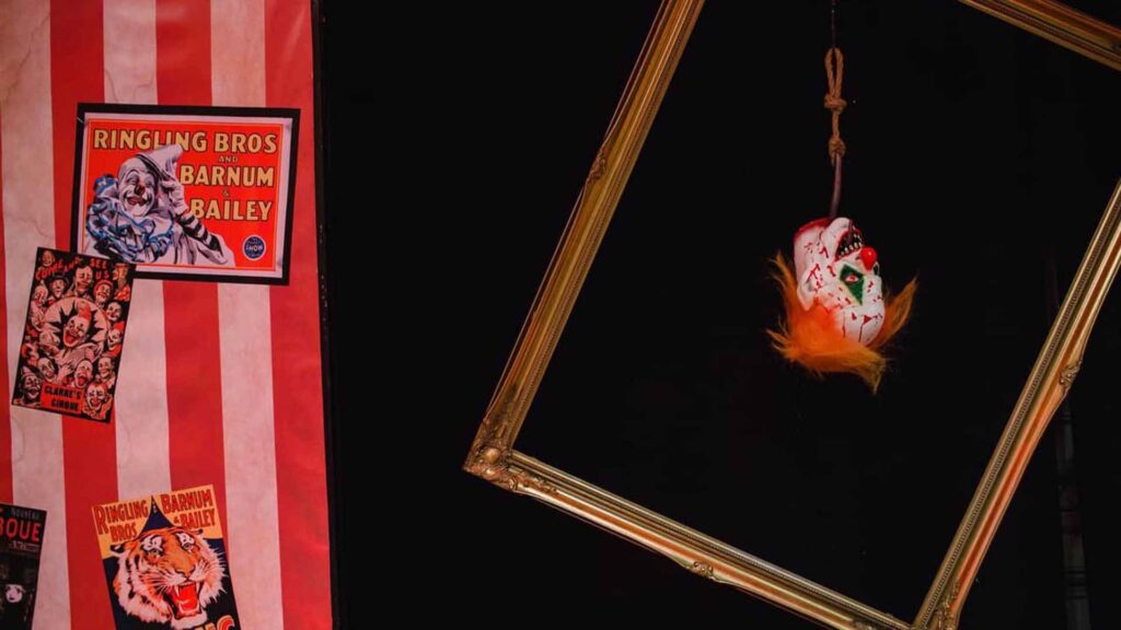 Picture frame with hanging clown head prop inside the frame