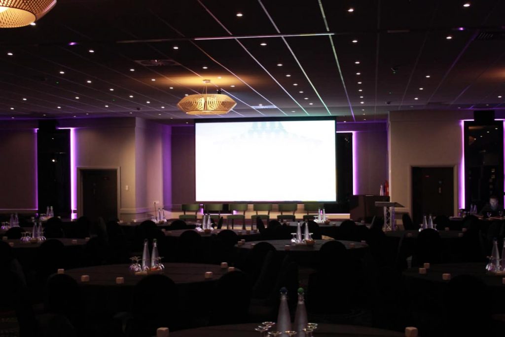 Opus conference stage set up and screen.