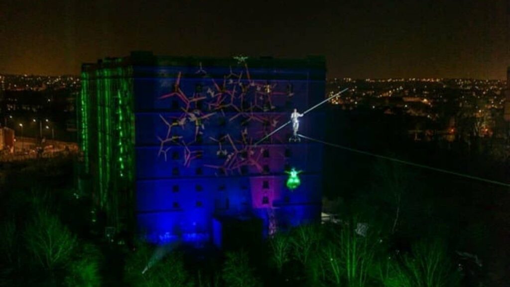 Lighting projection on building with brand logo.