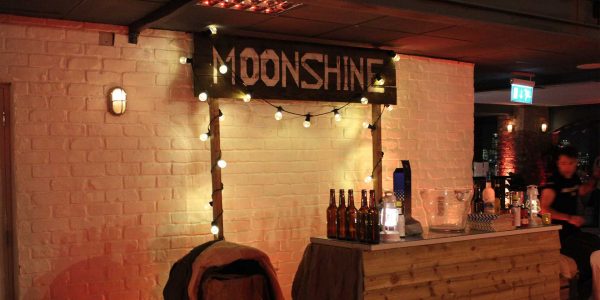 Prohibition themed party with moonshine bar prop hire and full venue dressing.
