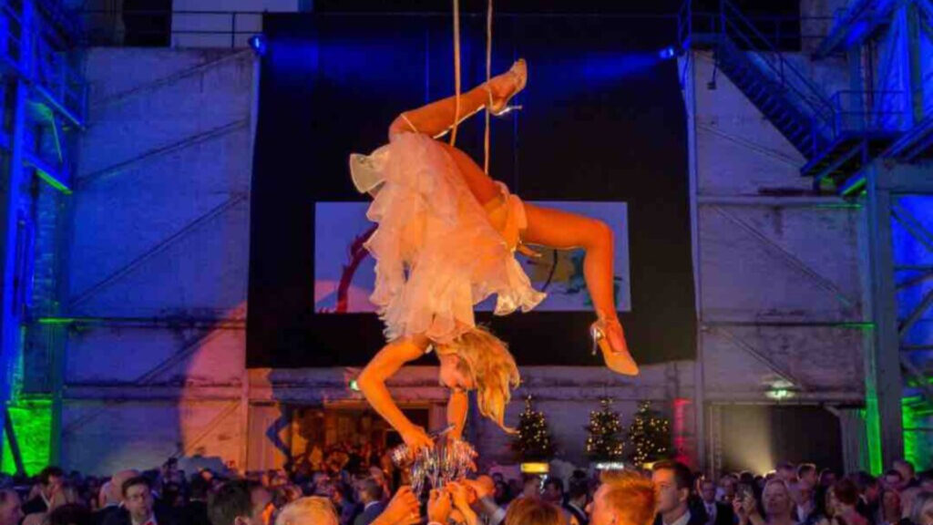 an aerial champagne pourer serving guests from the ceiling for cabaret style shows.