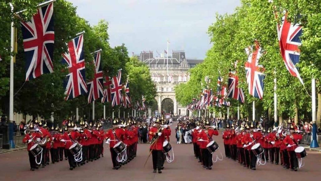 Brass band parading down London streets in front of Buckingham palace