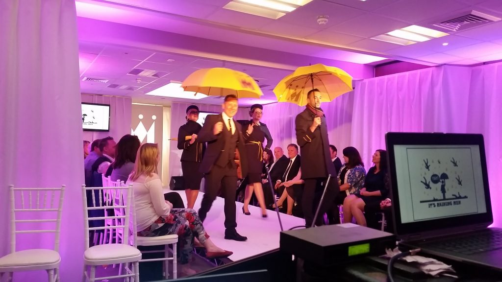 Monarch Fashion Show models on stage.