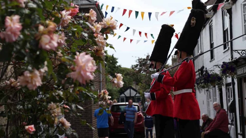 The Queens guard stilt walkers as part of entertainment for quintessentially British themed event