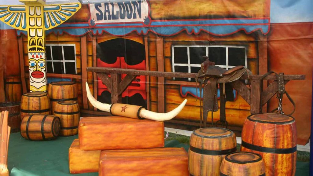 Bespoke wild west theming featuring , wild west town backdrop and cowboy venue theming.