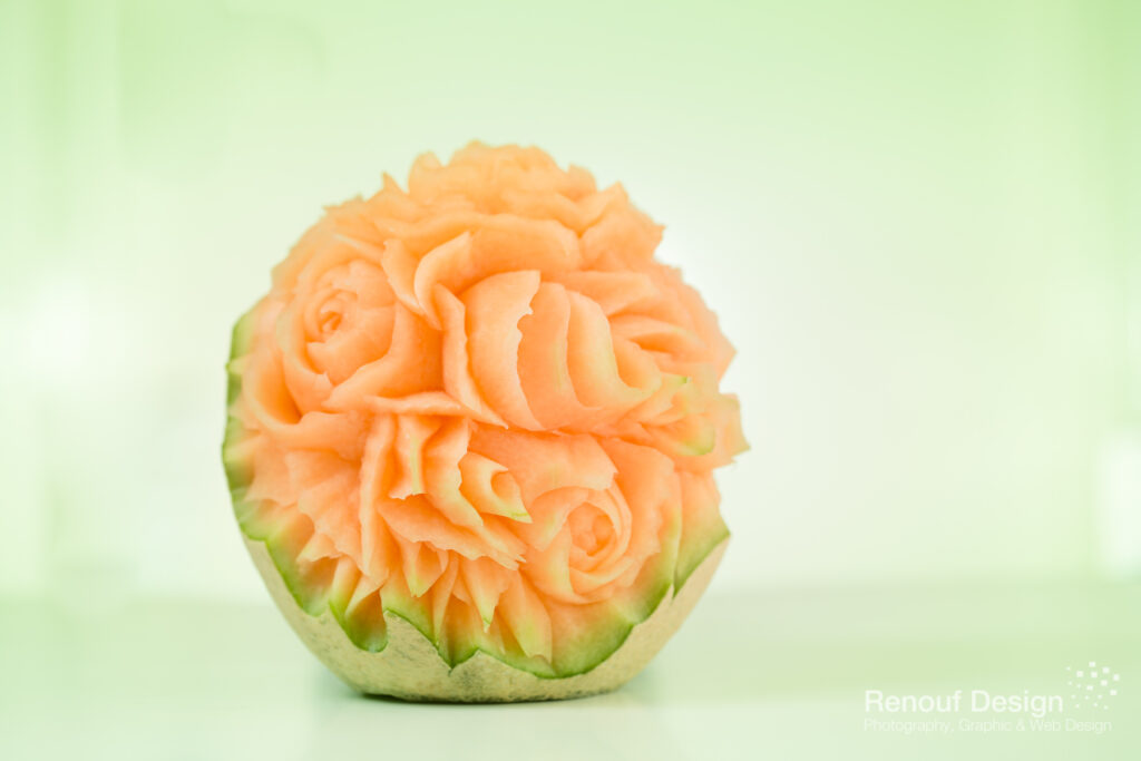 Intricate flower design carved into melon. Created by our virtual food carver.