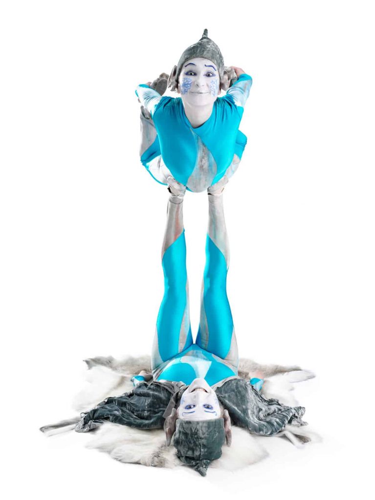Acrobatic Icy Elves wearing their bespoke icy costumes in a bright blue, silver and white. Our Acrobatic Elves are available for hire across the UK.