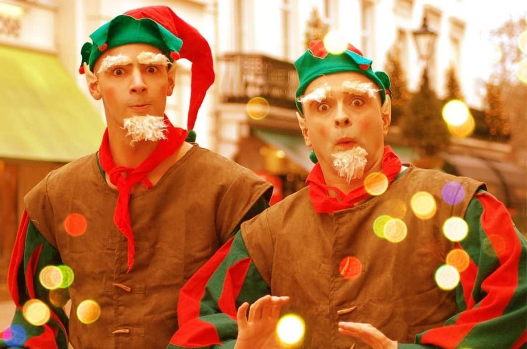 Comedy Elves performing at a Christmas Street parade event in the UK. This Elf Duo wear bespoke elf costumes with red and green colours and interact with your guests.