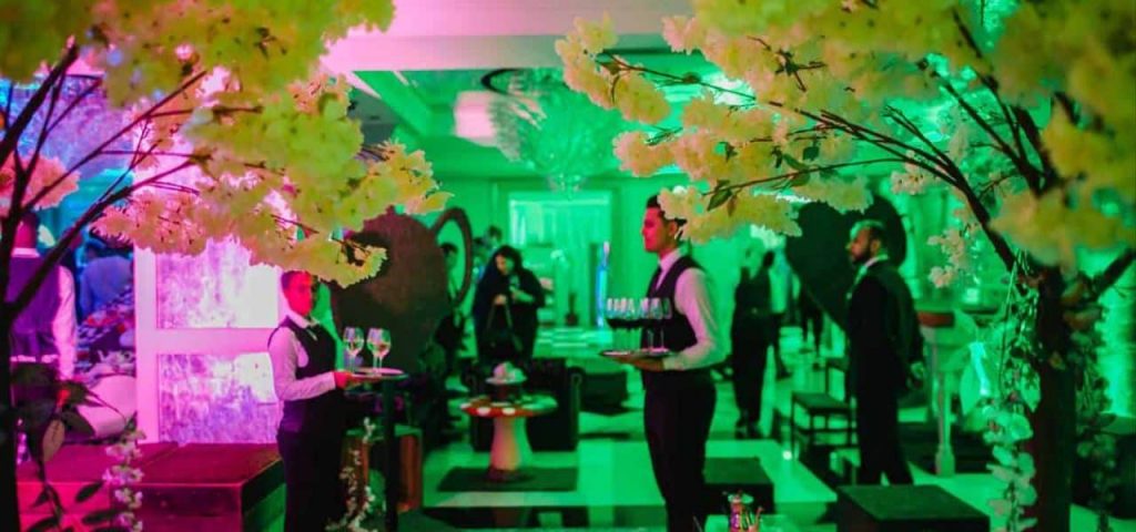 Waiter carrying champagne glasses at Gala Dinner. Booked through Entertainment and Catering services supplied by our event management team