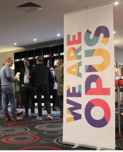 'We are Opus' signage at conference.