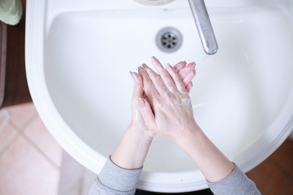Women washing hands in sink as part of new wedding venue covid-19 guideline