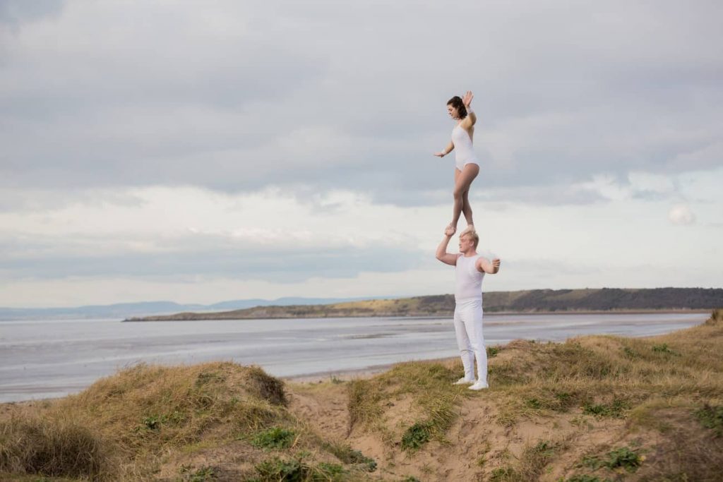 Acrobatic Dance Duo performing a dance routine outside on the UK coast. This unique Acrobatic Dance Duo perform amazing routines at private and corporate events in the UK.