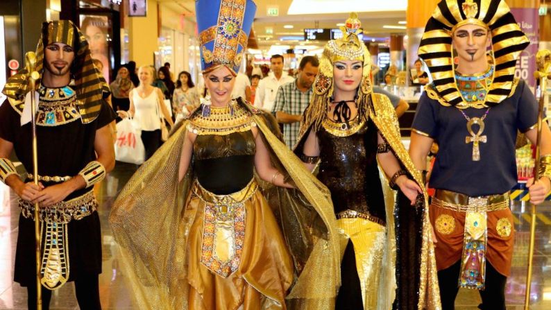Egyptian performers crew dressed in gold roaming a shopping centre curated by entertainment organisers providing entertainment shows for hire