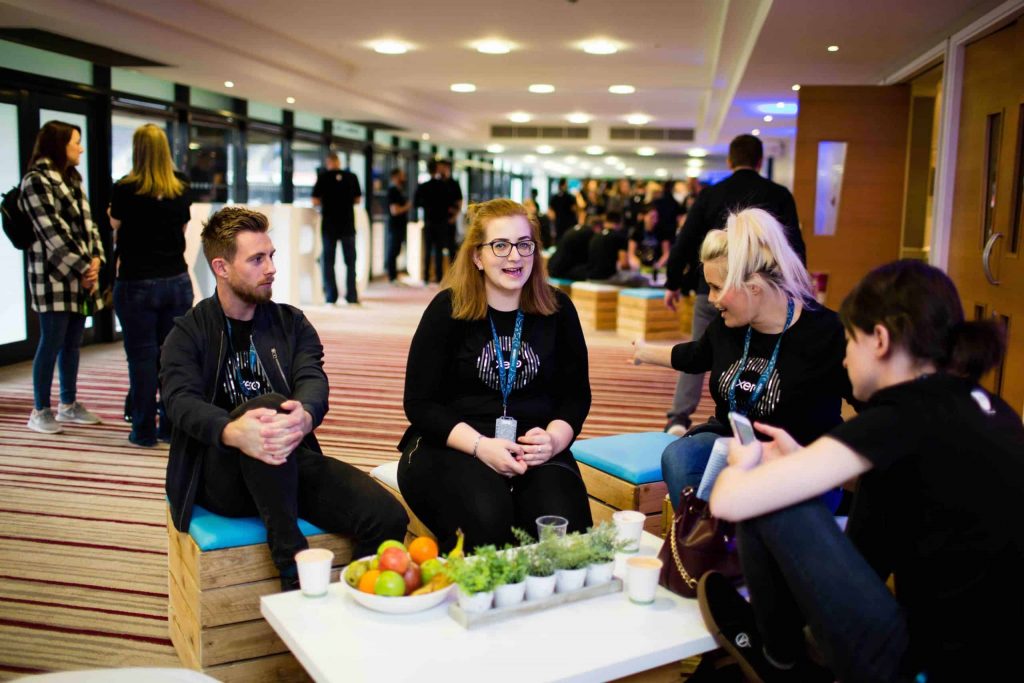 Guests of the Xero company conference event in Milton Keynes using the pallet furniture seating area at the event to socialise.