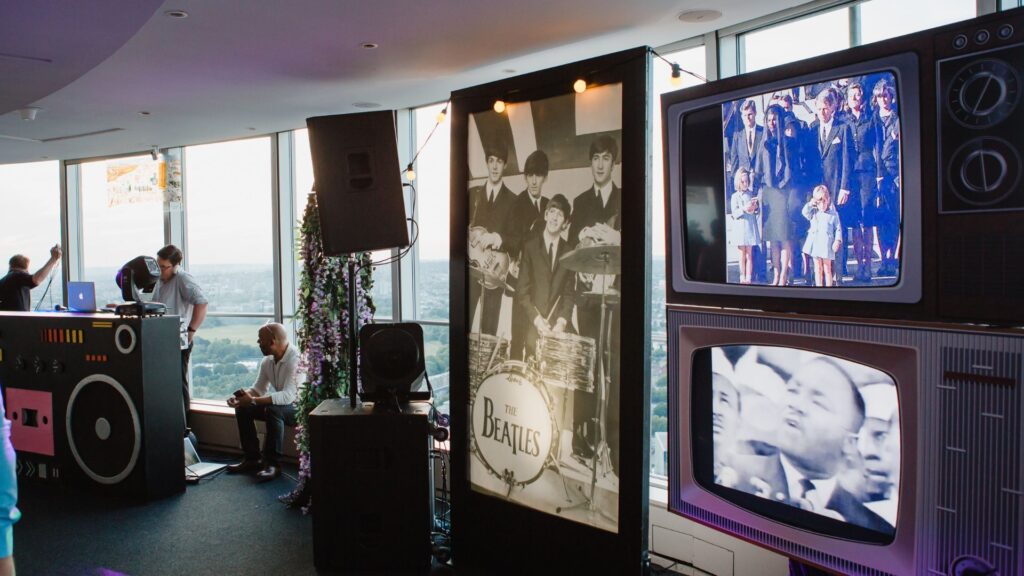 1960s themed event set design with retro posters and TV props.