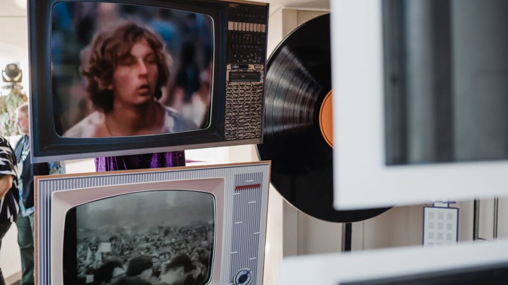 Close-up of retro TVs and record props used as set design entrance to a 1960s themed event.