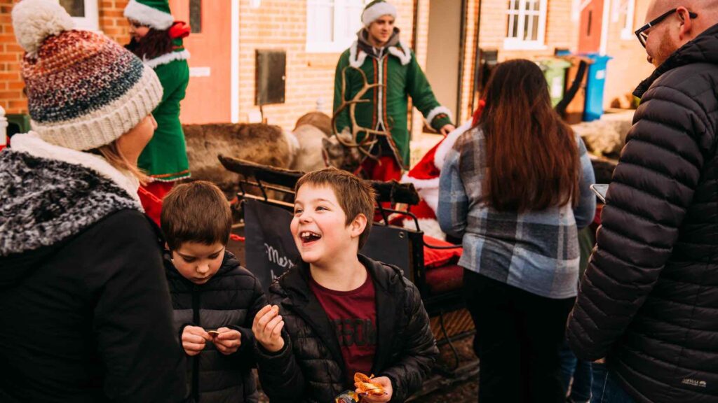 Children and adults enjoying a community event for Simple Life at a Christmas residential event.