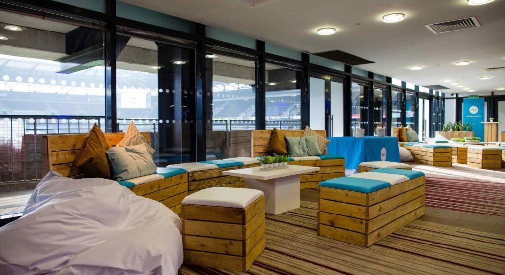 Stylish pallet furniture with blue seating in XERO brand colours for corporate conference breakout space.