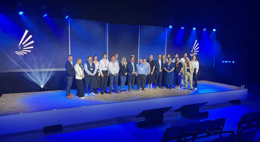 Conference audience on stage at an event produced and managed by our team.