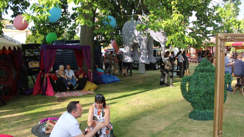Family Company Fun day event with elephant prop and guests enjoying the outdoor space in the UK