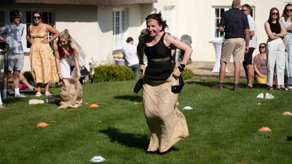 Woman competing against other guests in sack race