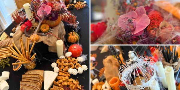 Detailing from floral pumpkin Halloween table dressing including spider, candles and flowers.
