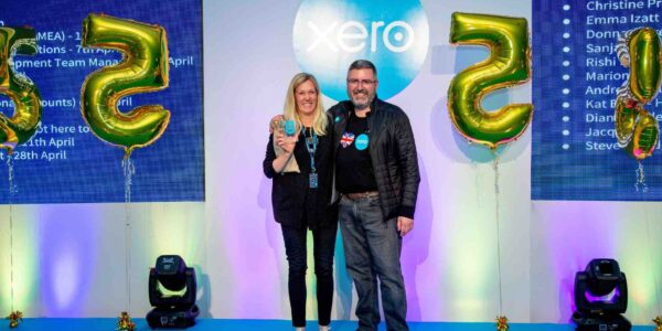 Members of staff stood side by side celebrating their awards at corporate conference.