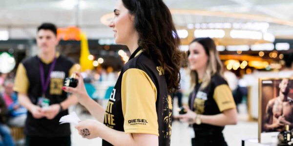 Employee-Handing-Out-Free-Samples-Of-Diesel