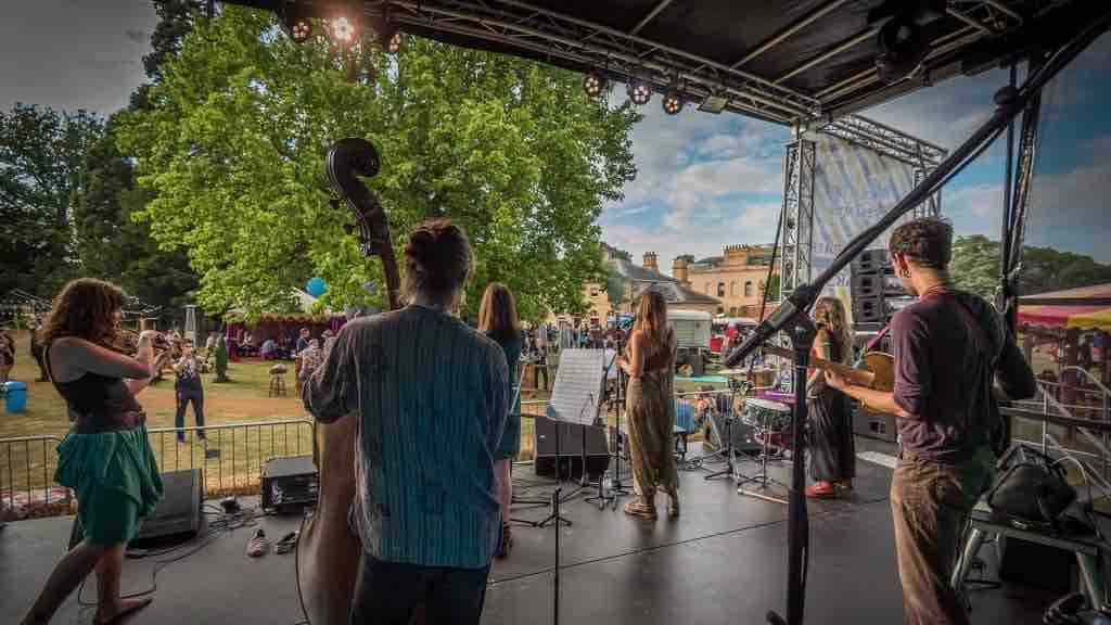 Event manager over seeing band on stage at festival event our organisation offer turnkey event management and production services for.