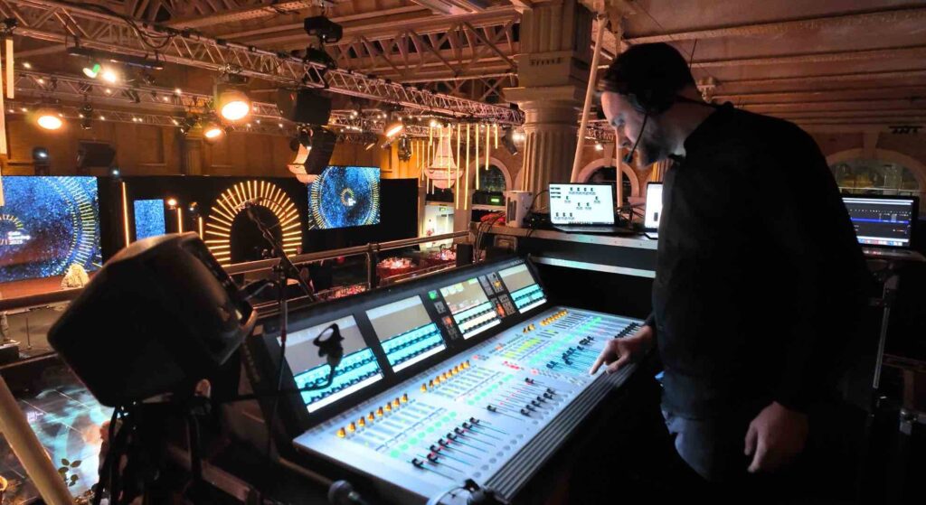 Lighting technician testing audio and visuals at this large gala event.