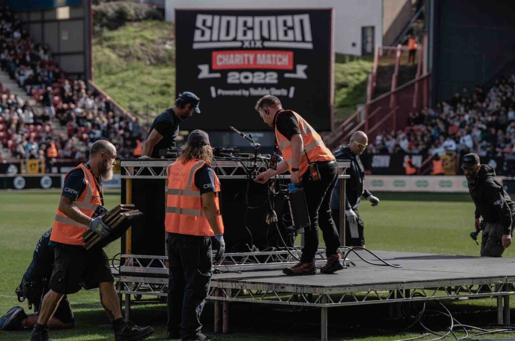 Team building stage on football pitch before kick-off.