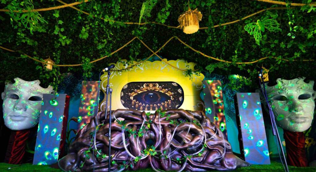 Tailor-made enchanted garden themed set and stage design with props, led projection and magical theming.