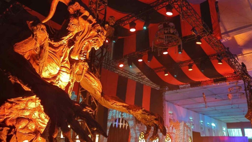 Saudi Arabia Horror Festival stage design with large creature prop enhanced with lighting and AV.