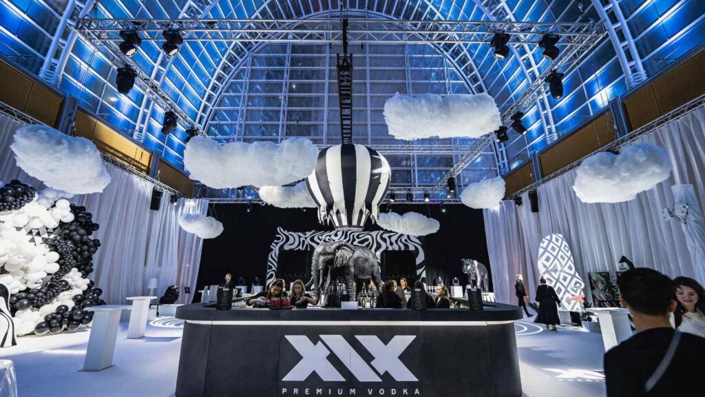 Front of floating balloon bar concept lit-up with projection lighting in-person for Sidemen 2022 Charity Match After Party.