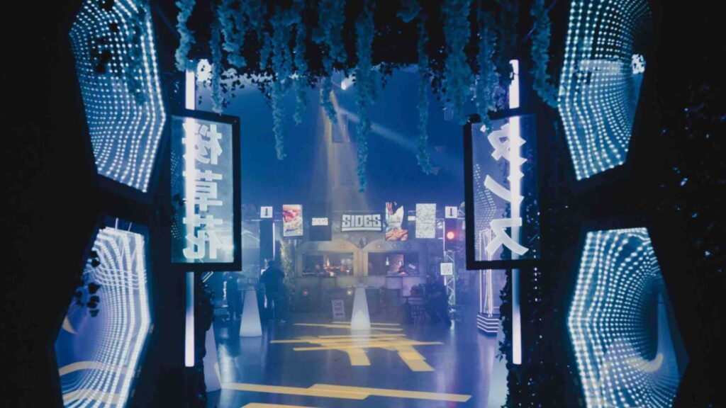 Entrance to Neon-Tokyo themed event space with projection lighting and neon signs.