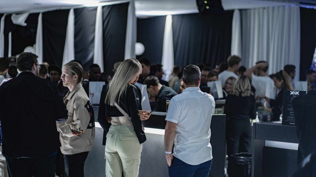 Guests talking at a Sidemen product launch event in London.