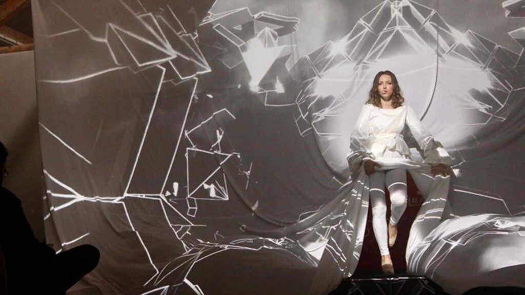 Product Launch 3D projection show with female dancer and white shape 3D projections.