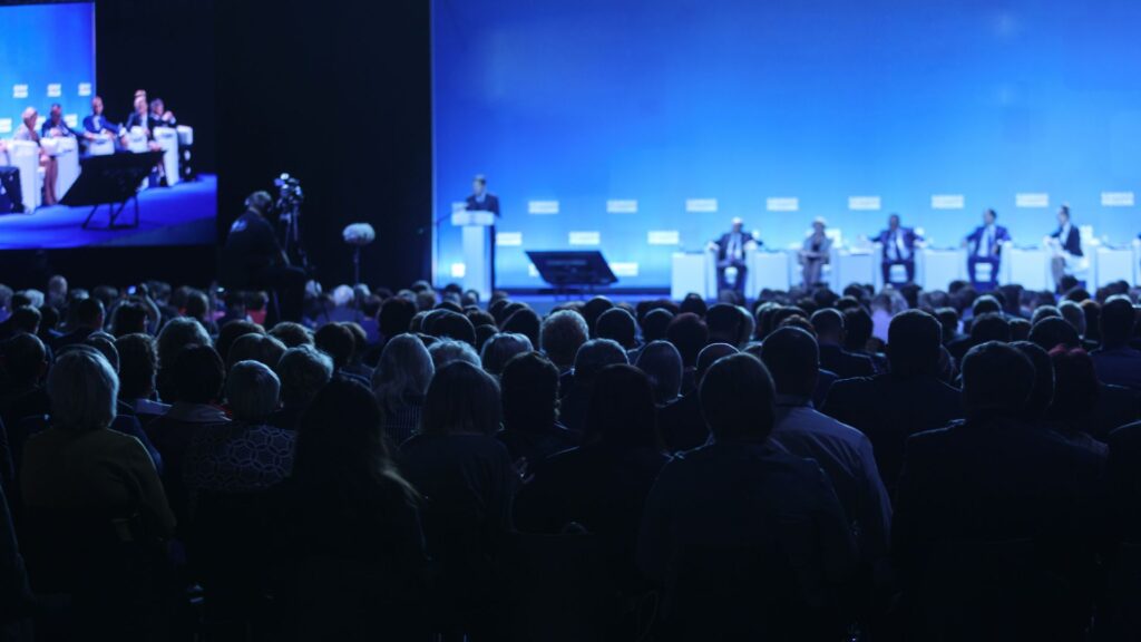 Guest Speakers on stage at corporate event speaking to LIVE audience.