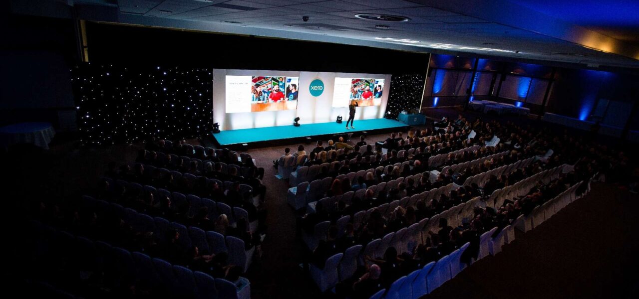 Speaker-On-Stage-At-Corporate-Conference-Near-London