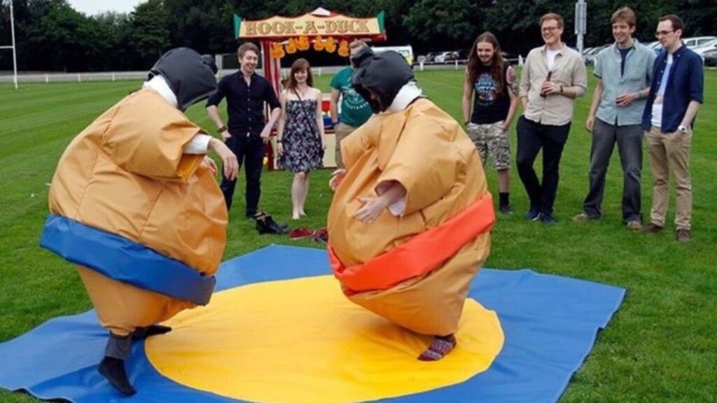 Two guests dressed in inflatable sumo wrestling suits at outdoor fun day event