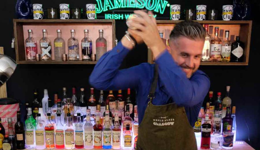 Virtual cocktail making workshop bartender teaching guests how to make cocktails for virtual team building events