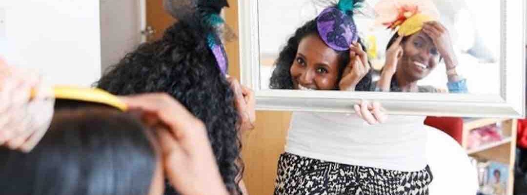 Guests-Looking-At-Fascinator-Creations-In-Mirror Guests-Looking-At-Fascinator-Creations-In-Mirror