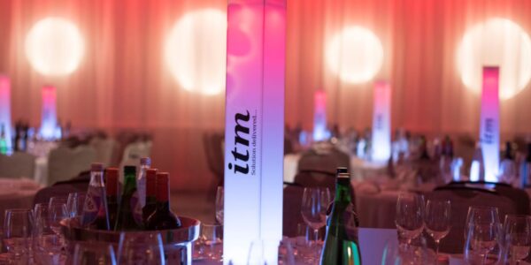 Custom built block branded table centrepieces at corporate gala dinner event for adding sophistication.