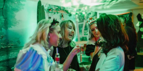 Guests-Enjoying-Company-At-Alice-In-Wonderland-Themed-Christmas-Event