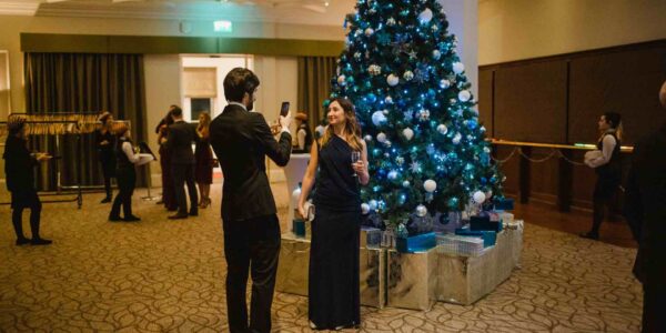 Guests-Posing-At-Christmas-Tree