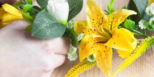 Guest-Making-Spring-Wreath-With-Yellow-And-White-Flowers
