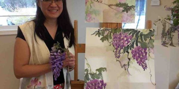 Artist-Posing-With-Flower-Painting