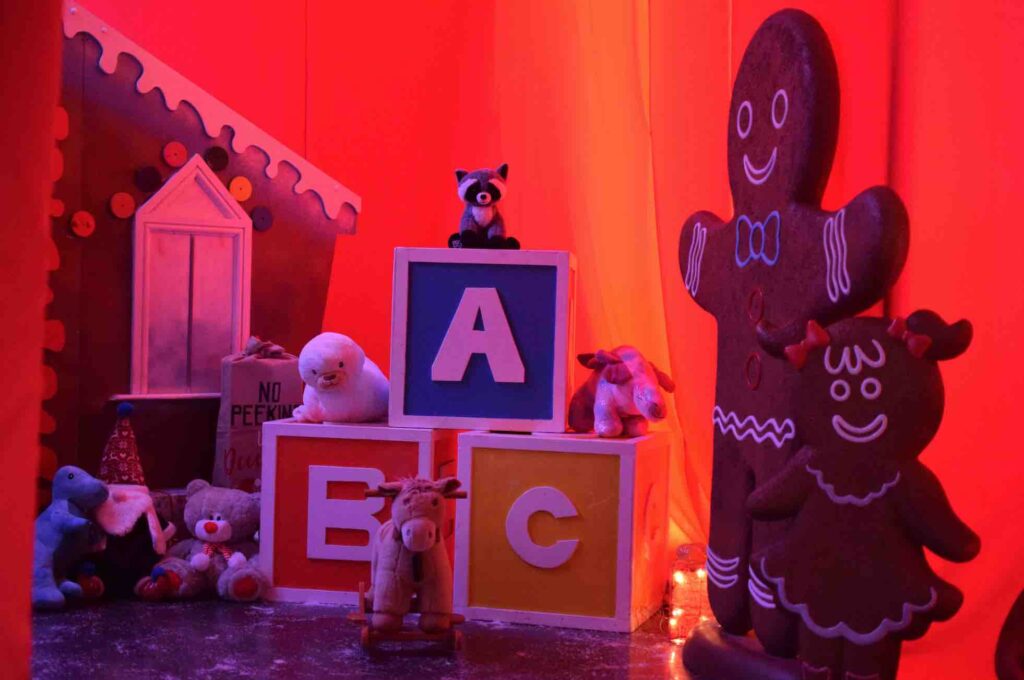 Giant building blocks, gingerbread men, cuddly toys and fake snow used to decorate Santa's workshop for Christmas activation event.