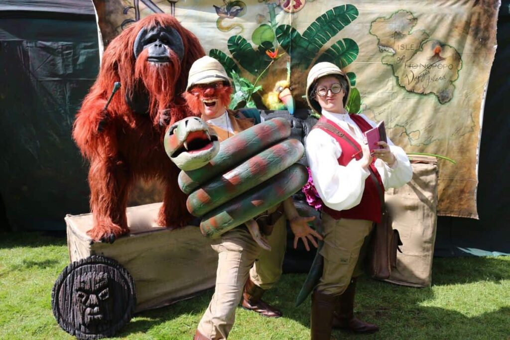 Animal Puppet Show performers and props including an animatronic gorilla and zoo keepers.